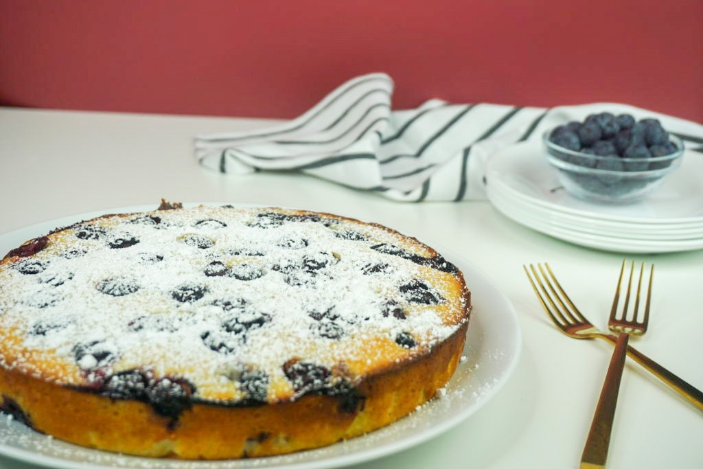 plated cake with blueberries and forks 