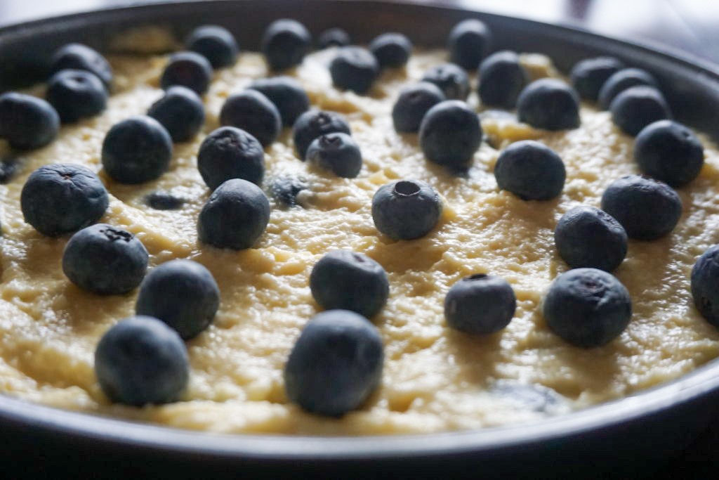 fresh blueberries on top of the cake batter 