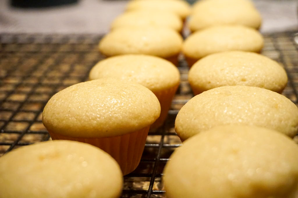 vanilla mini cupcakes on a cooling rack 