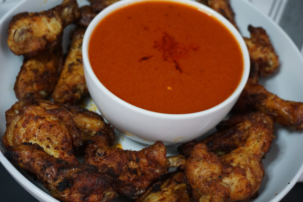 Buffalo sauce served with spicy chicken wings. 