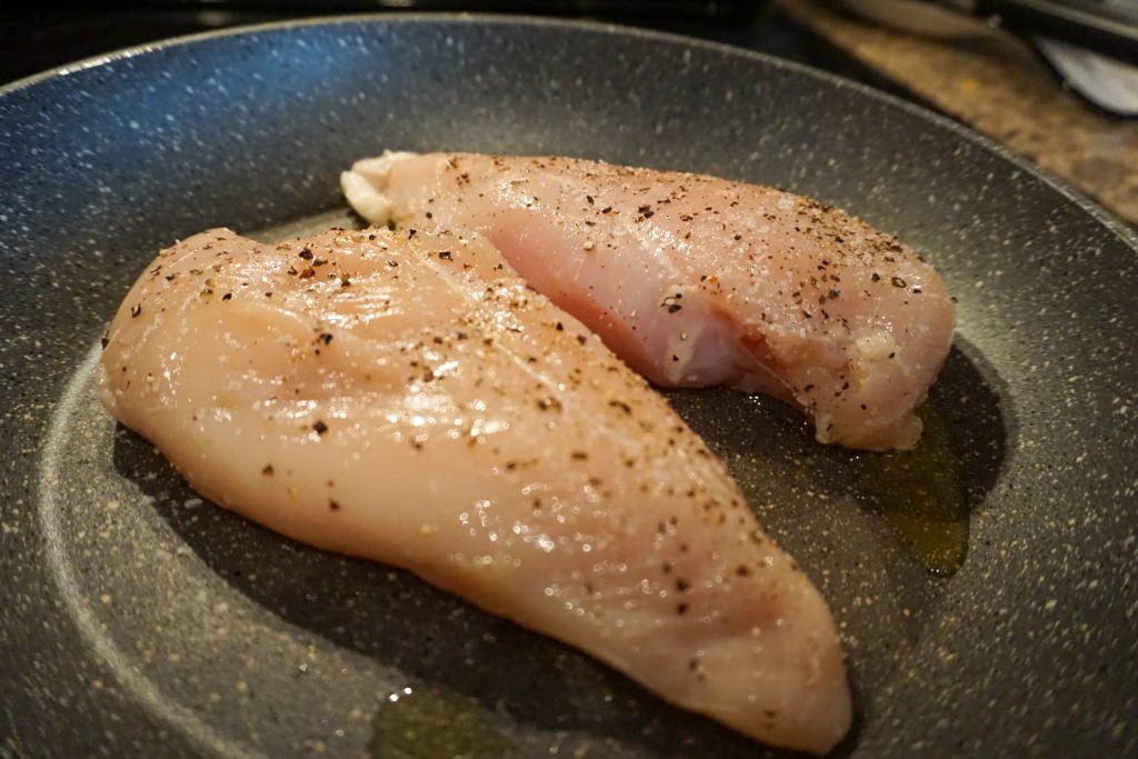 seasoning and searing the chicken breast 