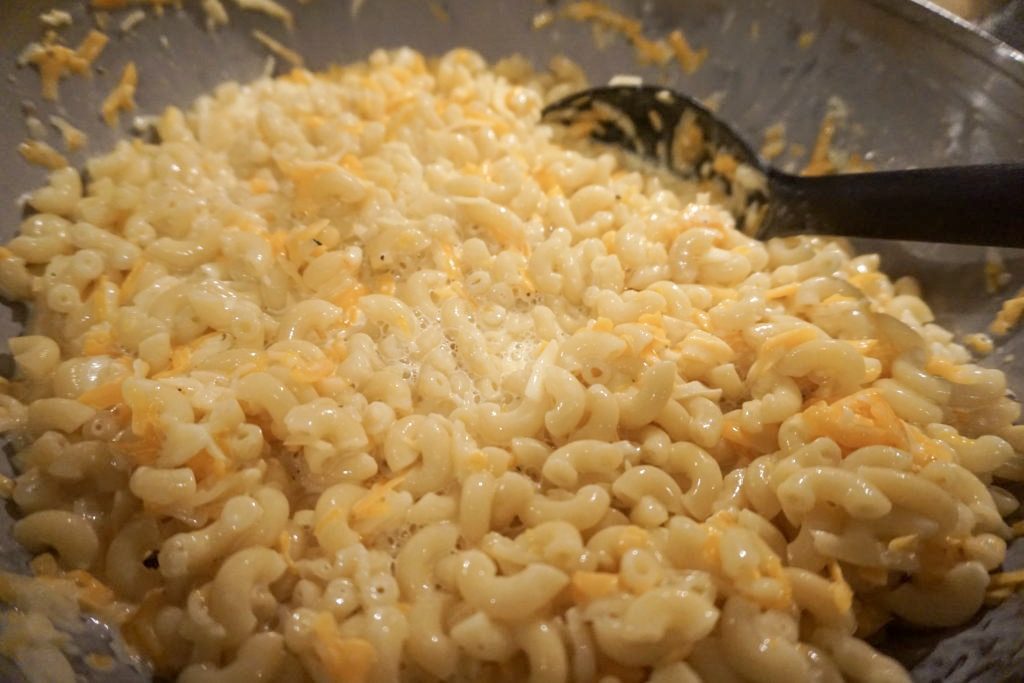 Mixing the macaroni and cheese together with eggs and half-and-half