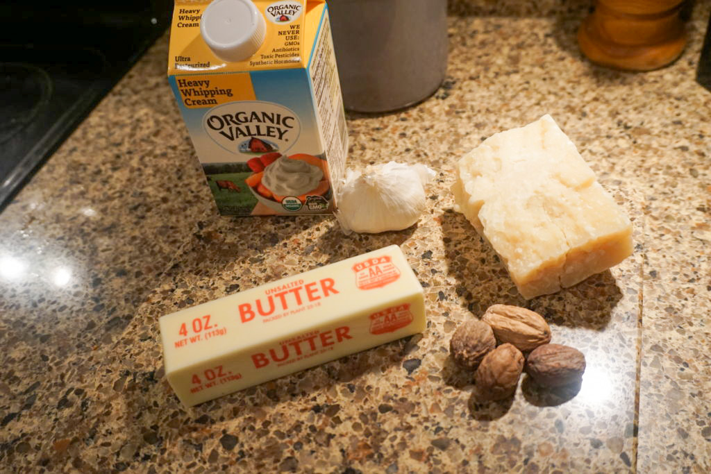 Ingredients used heavy whipping cream, fresh nutmeg, unsalted butter, garlic gloves, and Parmesan reggiano