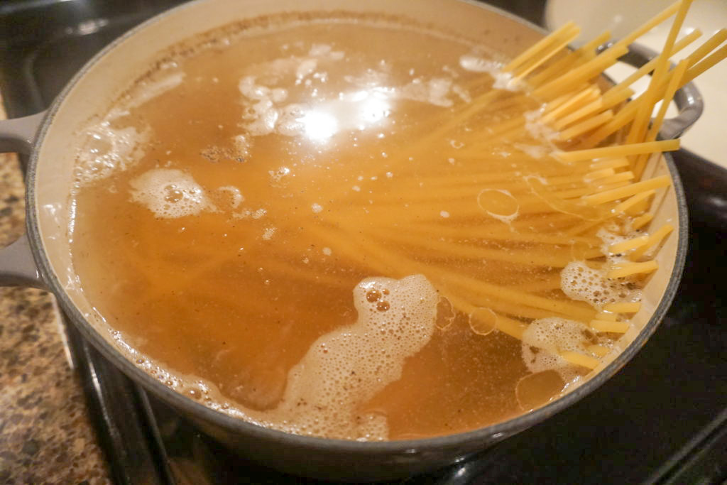 Seasoned pasta water with fettuccine noodles