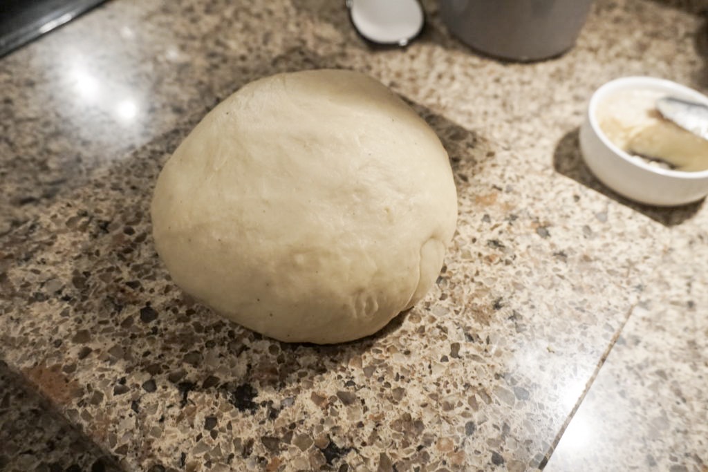 The brioche dough shaped into a medium sized ball