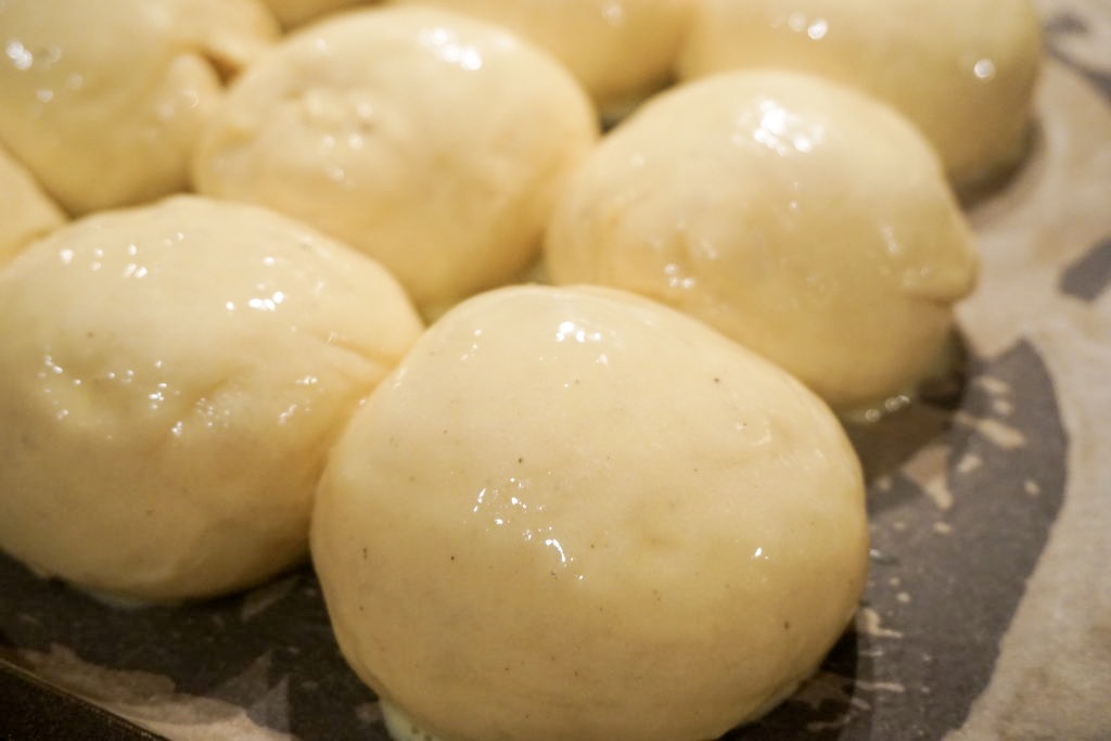 Close up of the egg wash on the brioche rolls