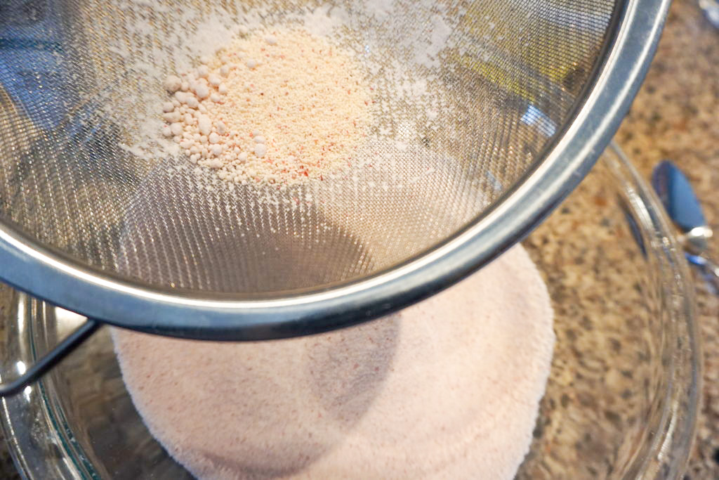 Sifting the dry ingredients and discarding the clumps