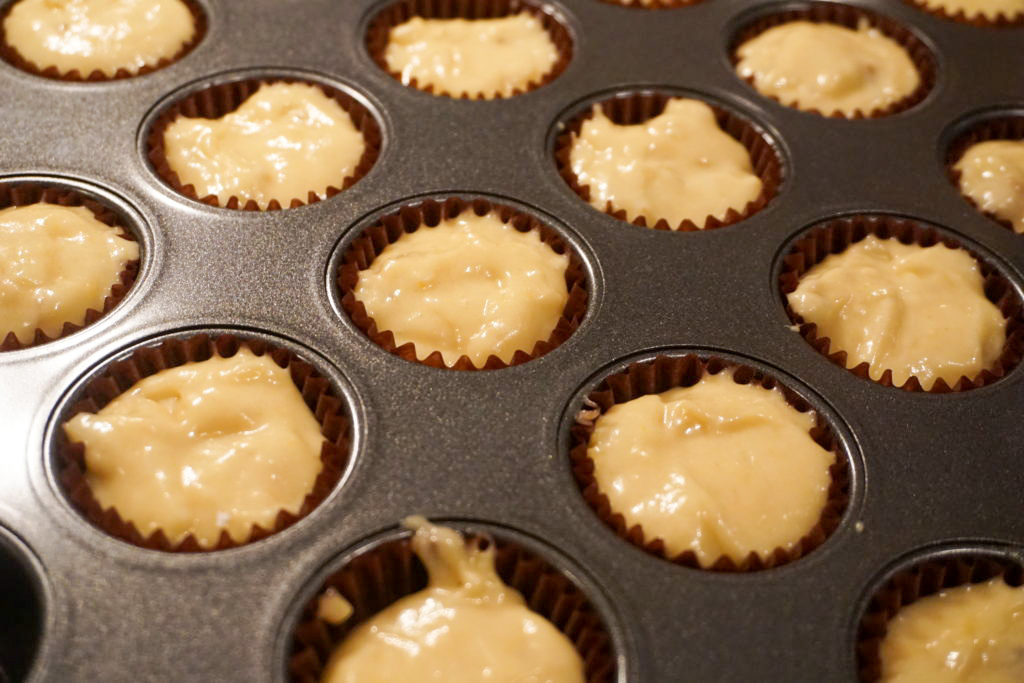 Close-up of the mini banana muffin batter in the muffin tin