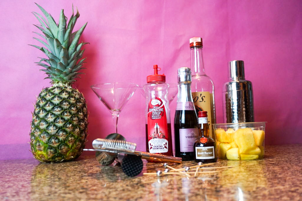 All the ingredients to the cocktail: pineapples, grand mariner, grenadine syrup, prosecco, and vodka