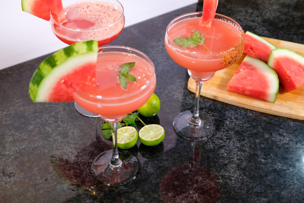 watermelon margarita with sliced watermelon on a board 