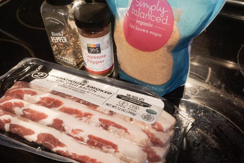 The ingredients used for the spiced brown sugar bacon. Ingredients include: red pepper flakes, light brown sugar, bacon, and fresh ground black pepper.